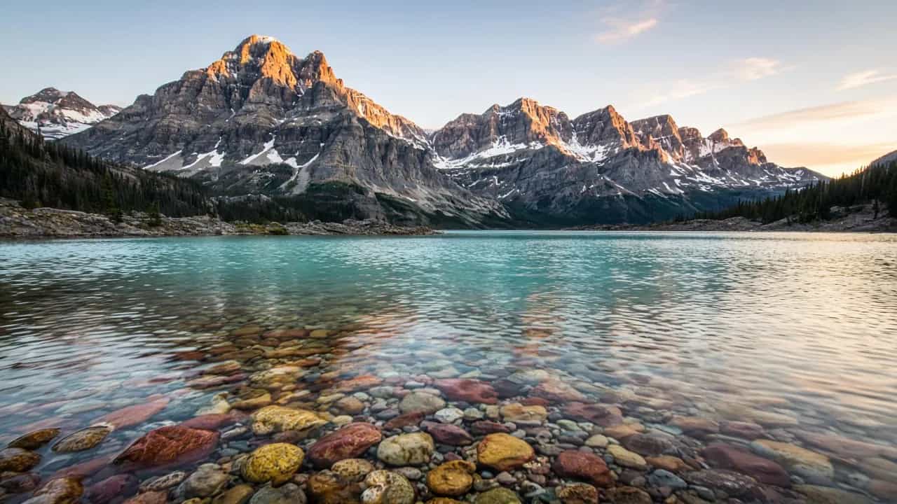 Glacier National Park mountains and turquoise lake at sunrise, Montana